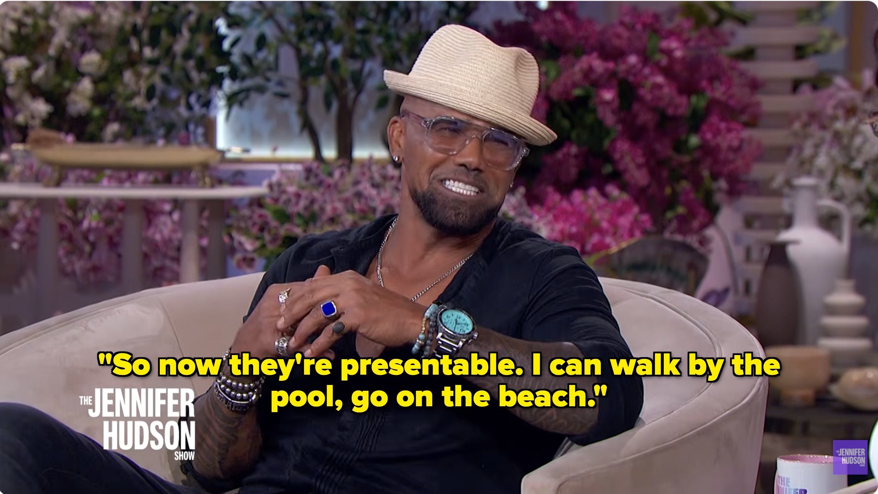 Person successful  a casual chapeau  and sunglasses sitting connected  a speech   amusement   acceptable   with purple floral background