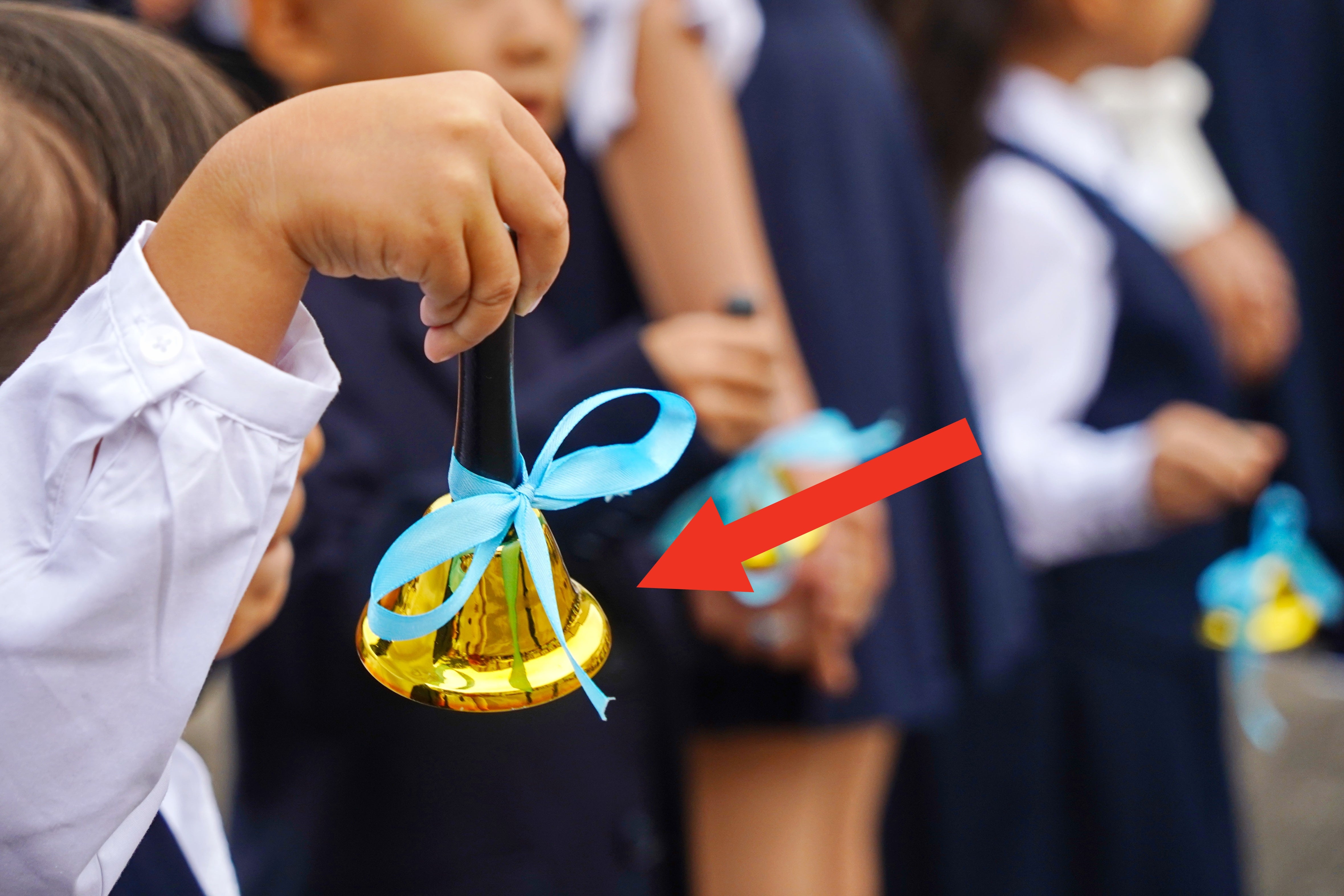 Children successful uniforms holding tiny bells with bows, perchance astatine a schoolhouse lawsuit oregon ceremony