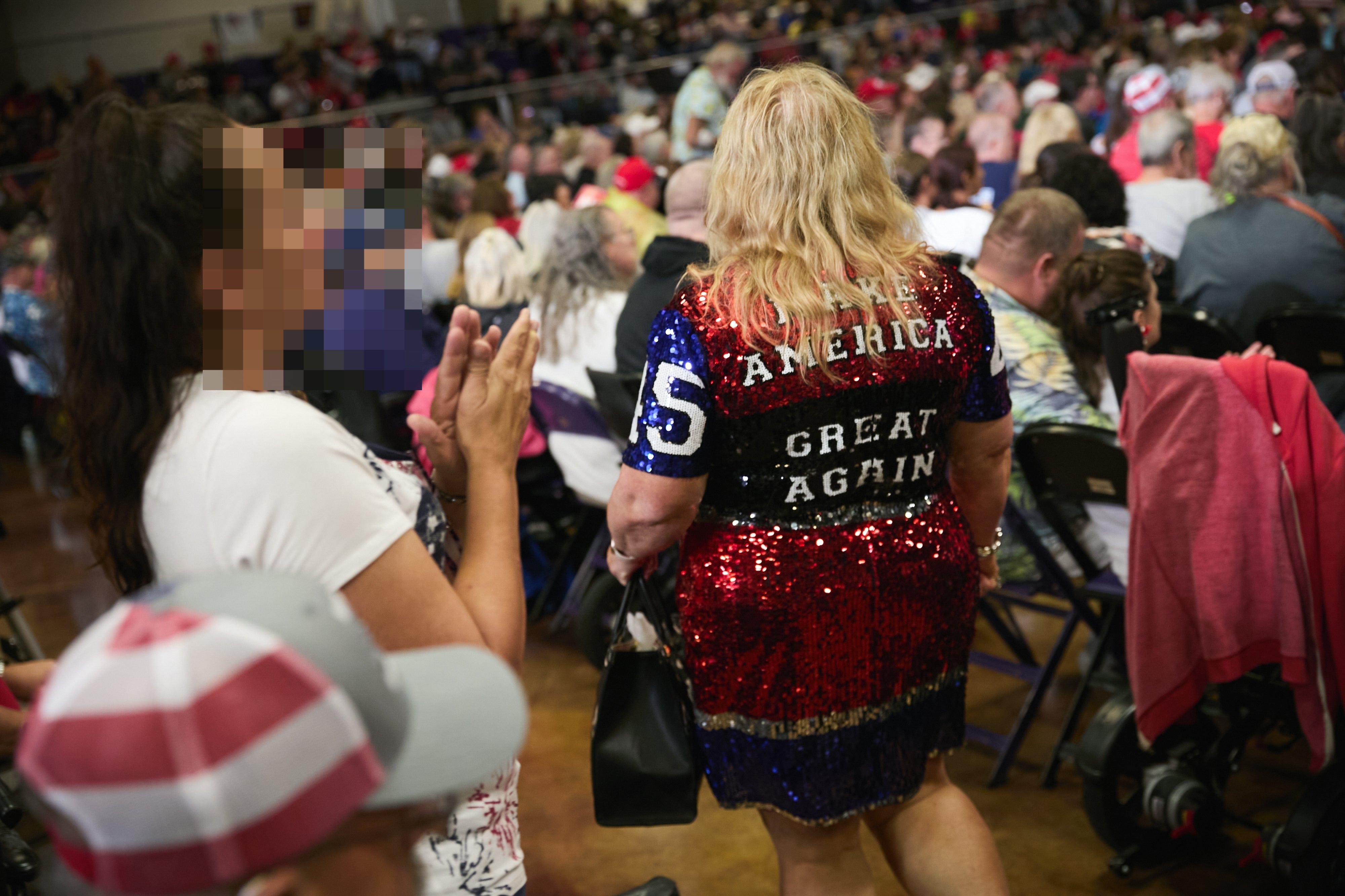 Person successful sequined formal with "Make America Great Again" attends crowded event