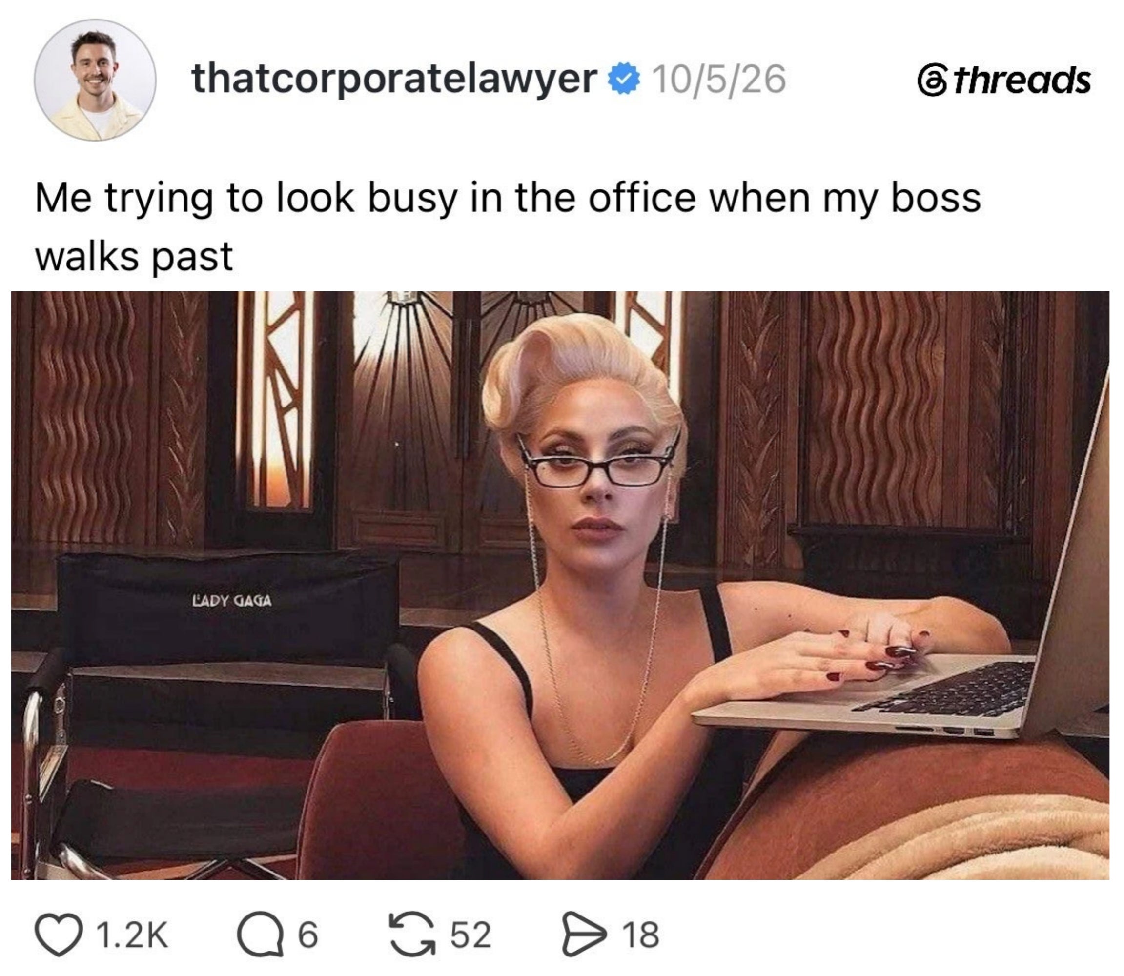 Person pretending to work on a laptop, captioned with humor about looking busy when the boss walks by