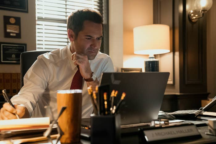 Man successful  bureau   setting, wearing a formal  garment  and tie, focused connected  a laptop, with pens and paperwork connected  the desk