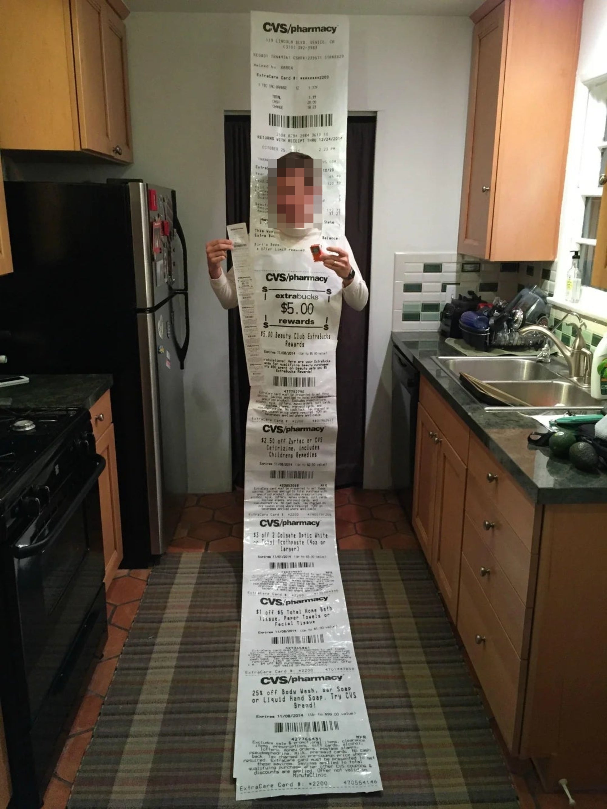Person holding an highly agelong CVS receipt, stretching from the person's hands to the floor, seemingly longer than the idiosyncratic is tall