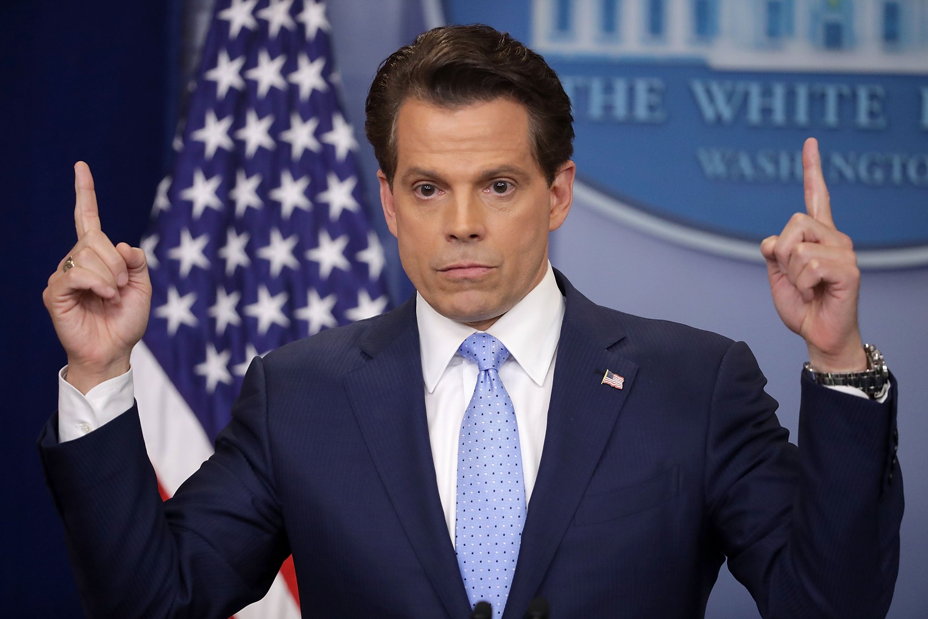 A idiosyncratic   successful  a suit   gestures with some  hands raised during a property   briefing astatine  the White House