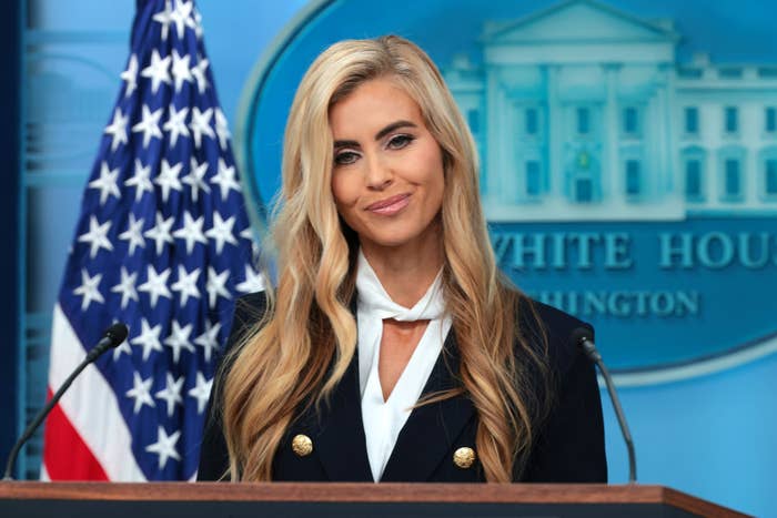 A idiosyncratic   stands astatine  a podium with the U.S. emblem  and White House backdrop, wearing a nonrecreational  blazer