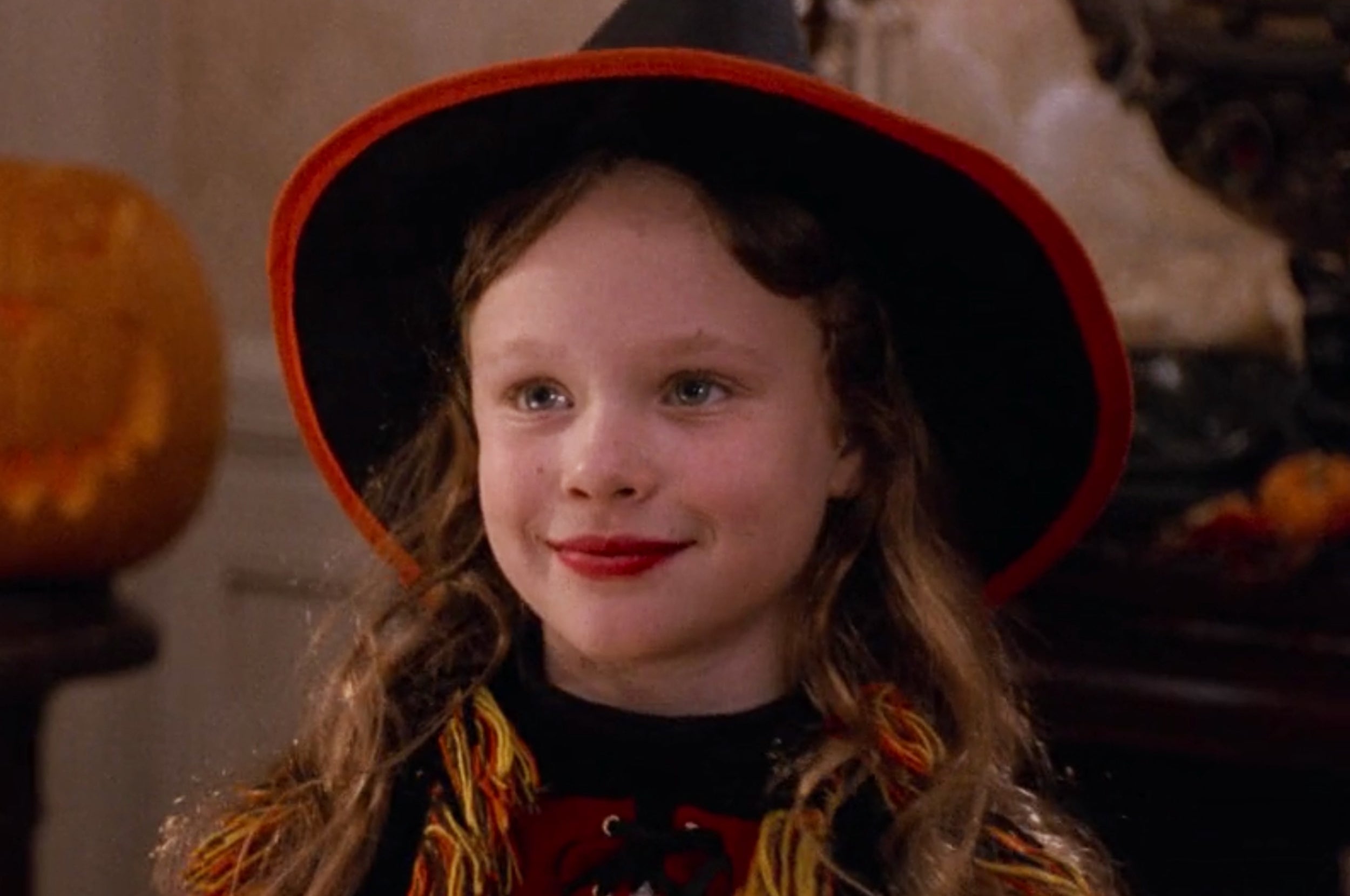Dani from Hocus Pocus smiling while wearing a witch costume