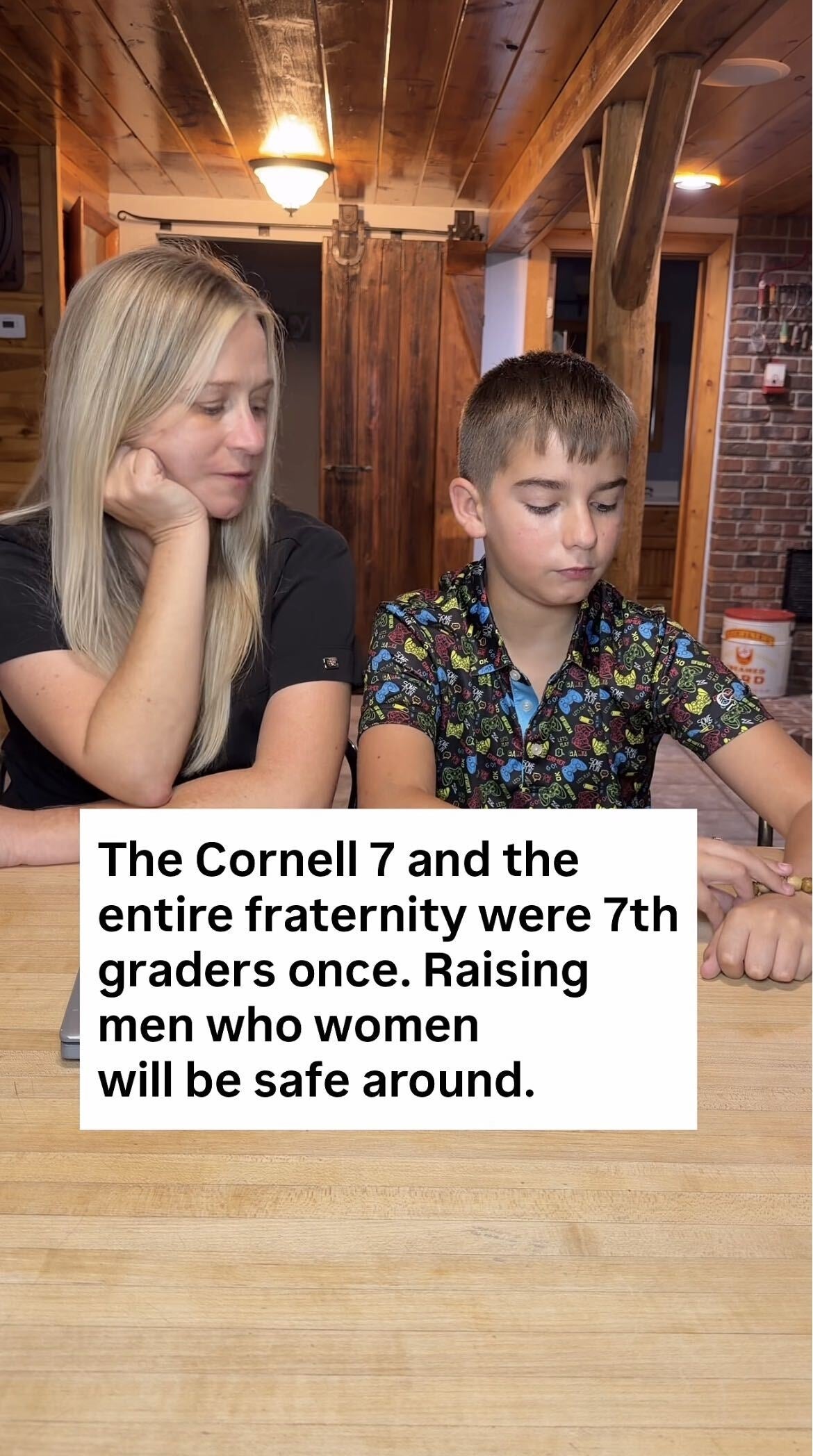 Woman and boy sit at a table. Text: "The Cornell 7 and the entire fraternity were 7th graders once. Raising men who women will be safe around."