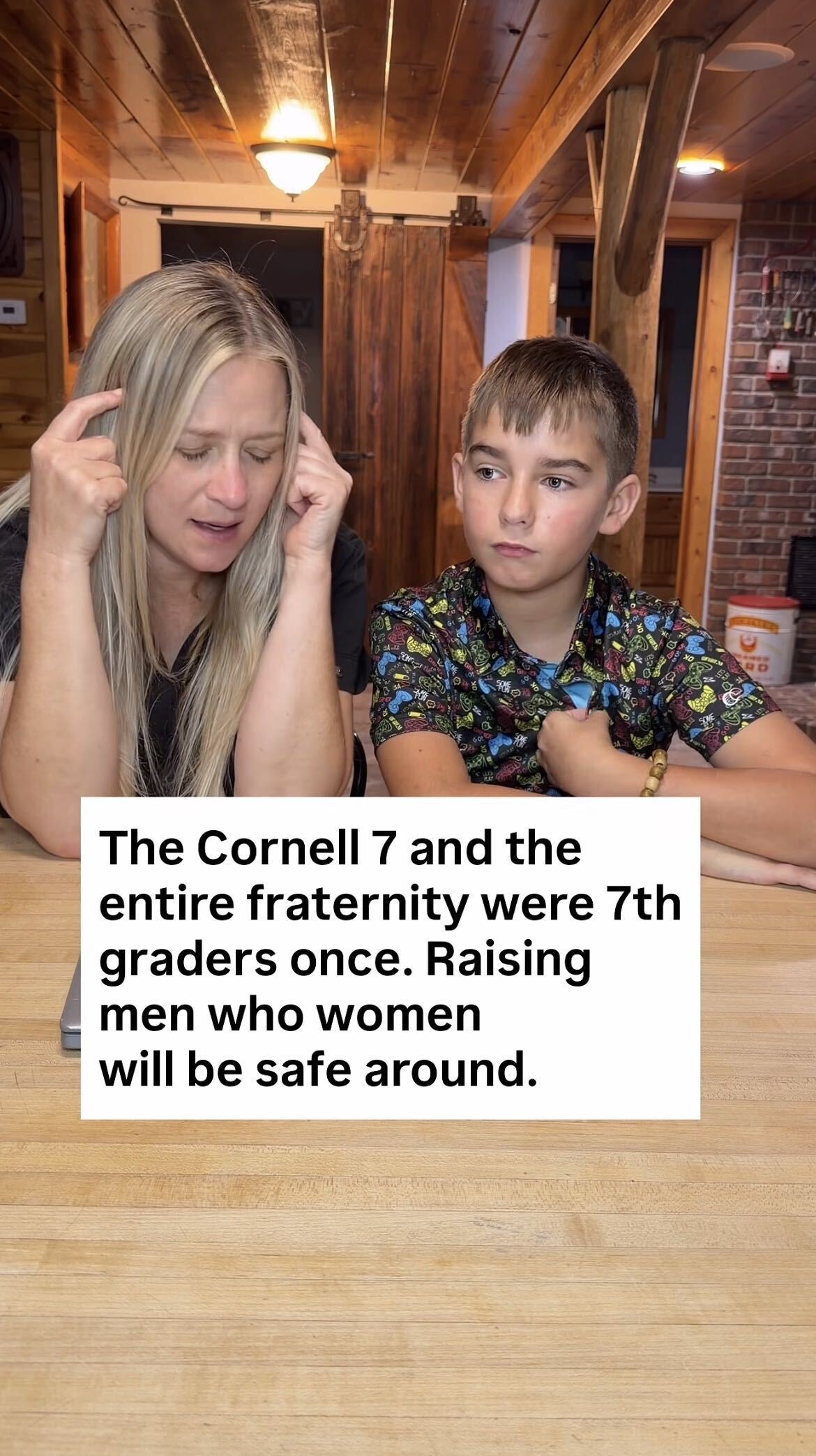 Woman sits with a boy at a wooden table. Text overlay reads: "The Cornell 7 and the entire fraternity were 7th graders once. Raising men who women will be safe 