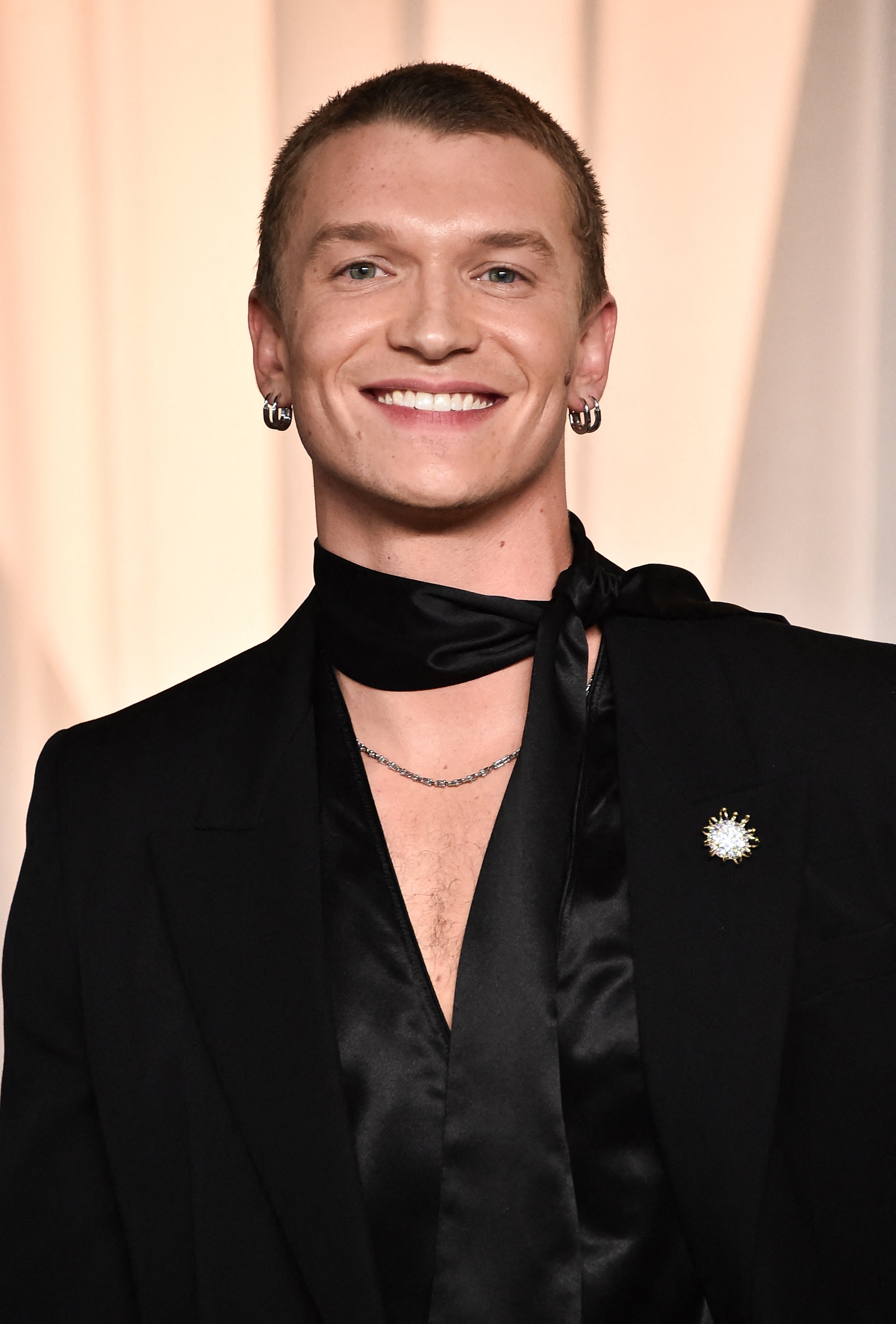 Connor Storrie smiling in formal black attire