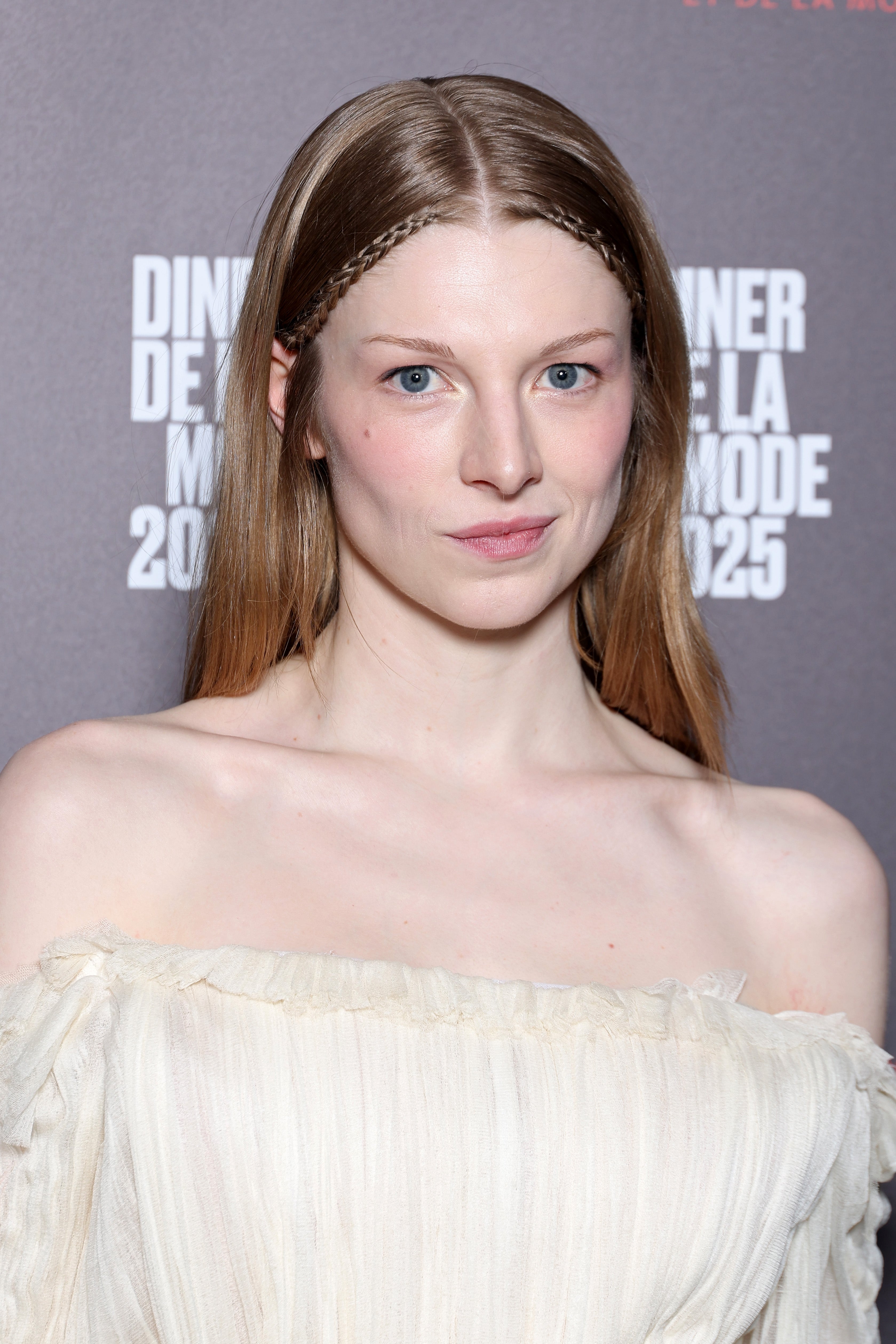 Person in an off-shoulder, flowing gown on a red carpet
