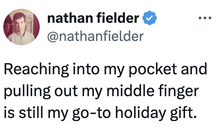 Tweet by @nathanfielder saying, "Reaching into my pouch and pulling retired my mediate digit is inactive my go-to vacation gift."