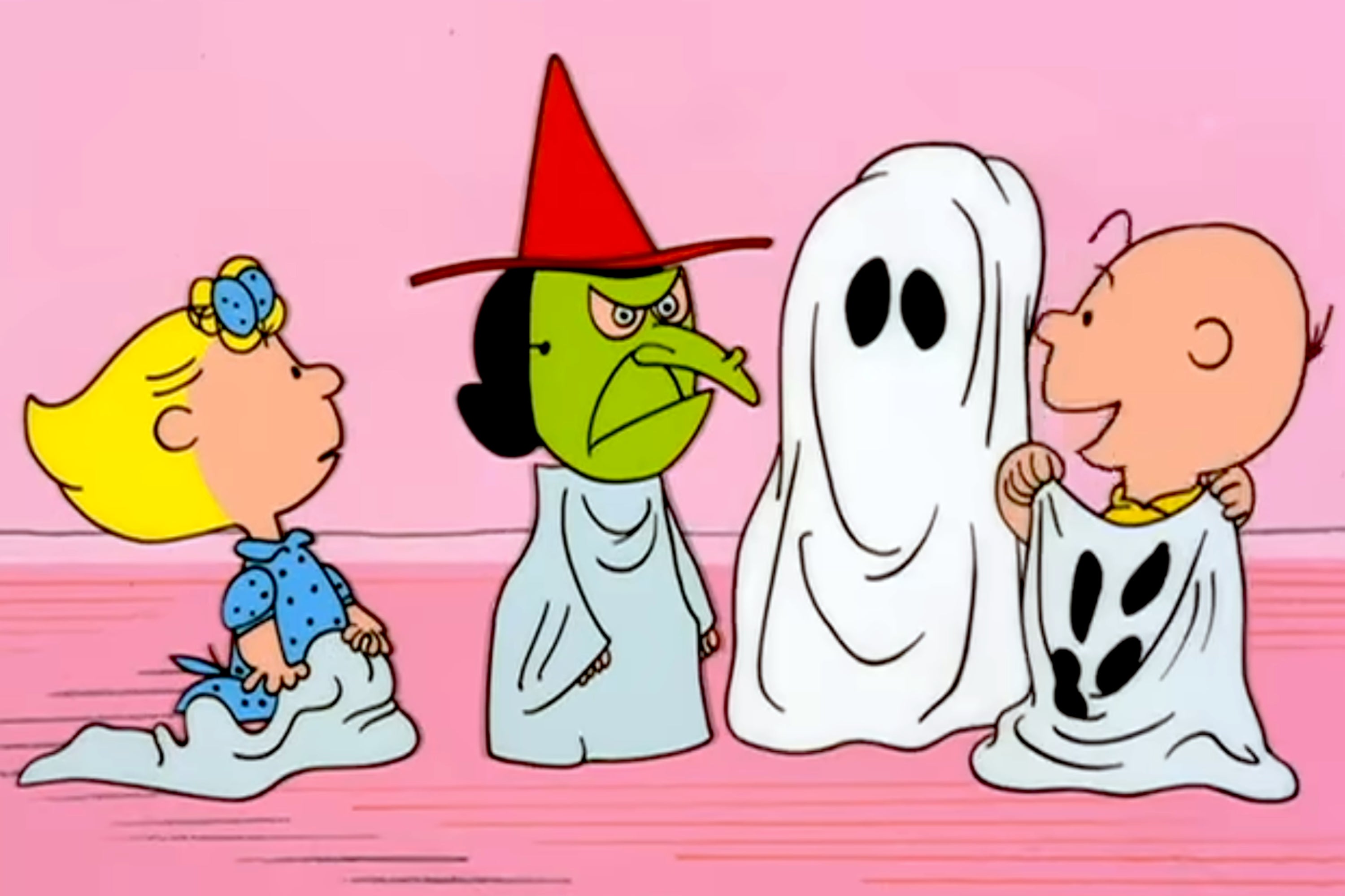 Cartoon characters in Halloween costumes: witch, ghost, and two kids with sheets. They're from a classic animated TV special