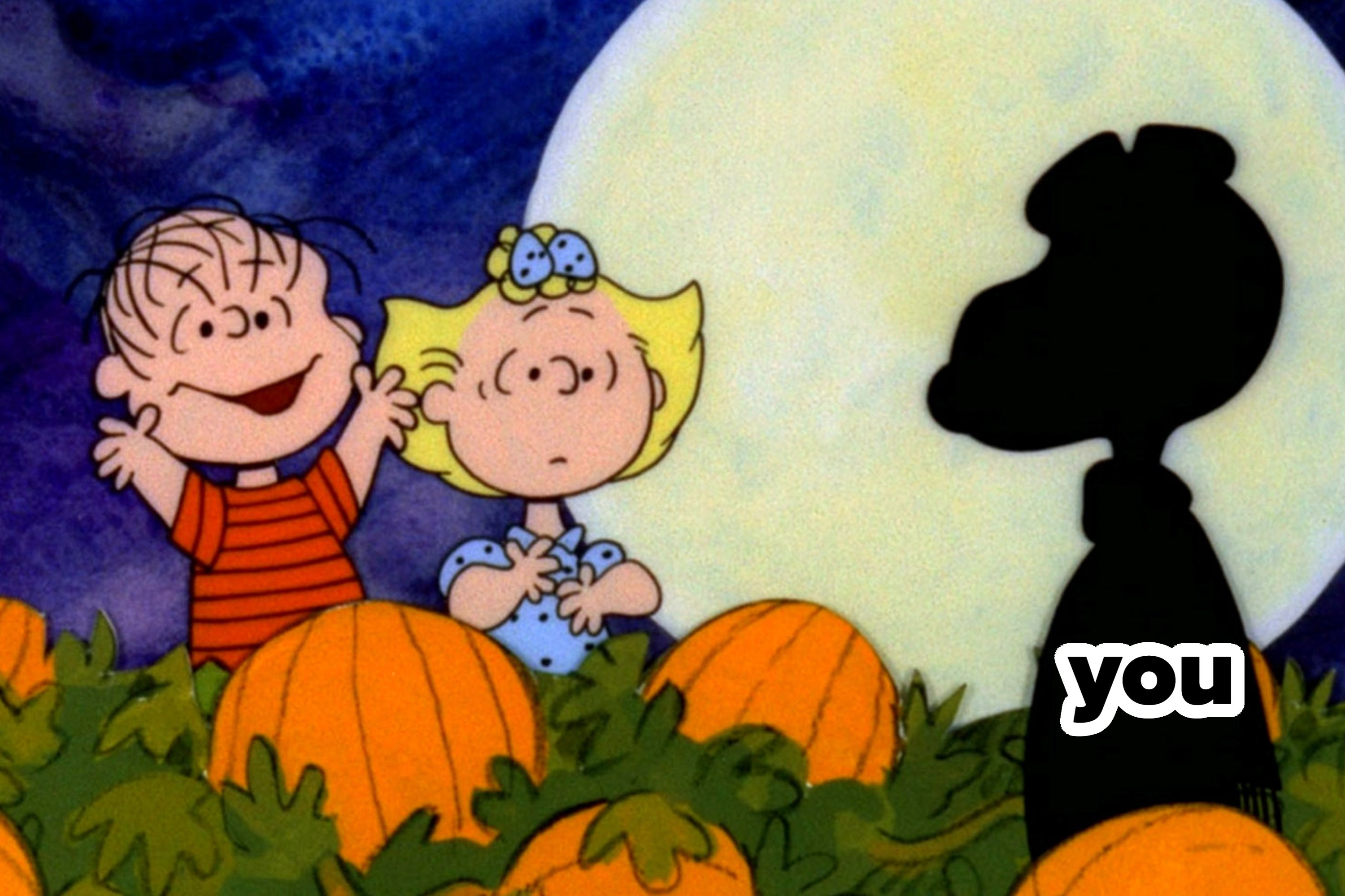 Linus and Sally from Peanuts stand in a pumpkin patch at night, with the silhouette of Snoopy near a large full moon