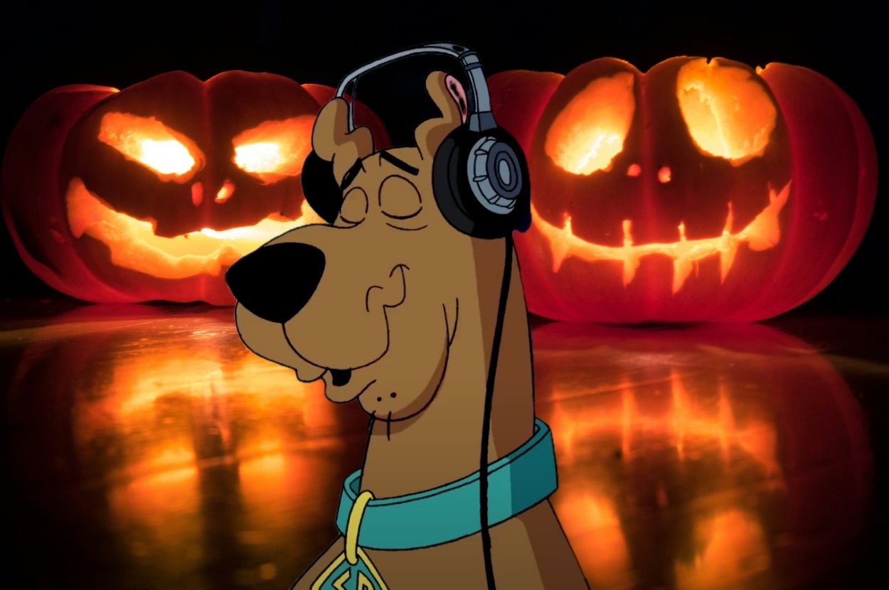 Animated Scooby-Doo wearing headphones, smiling with eyes closed, in front of two glowing carved pumpkins