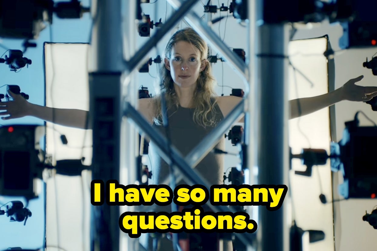 Woman standing in a room full of cameras with arms outstretched; text reads, "I have so many questions."