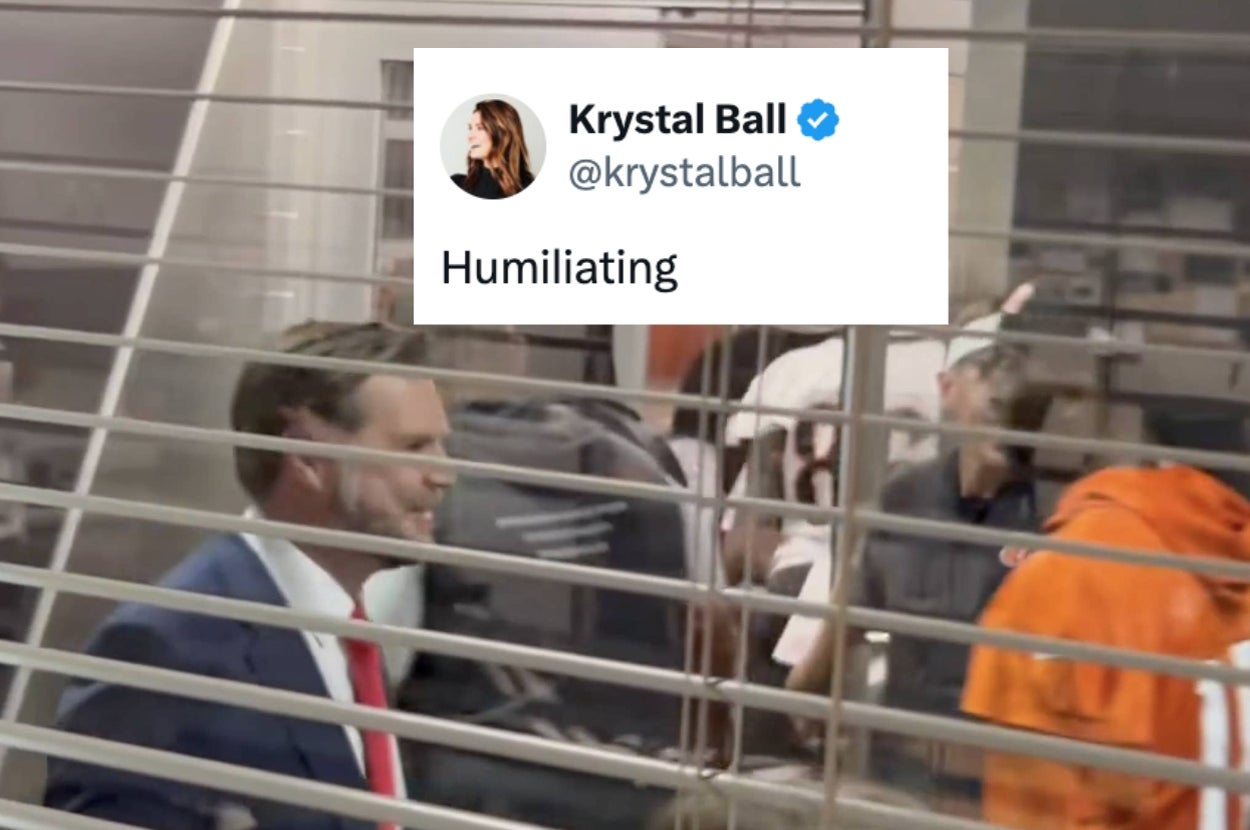 Text tweet overlay on blurred photo of a suited man and others; tweet reads, "Humiliating" by @krystalball