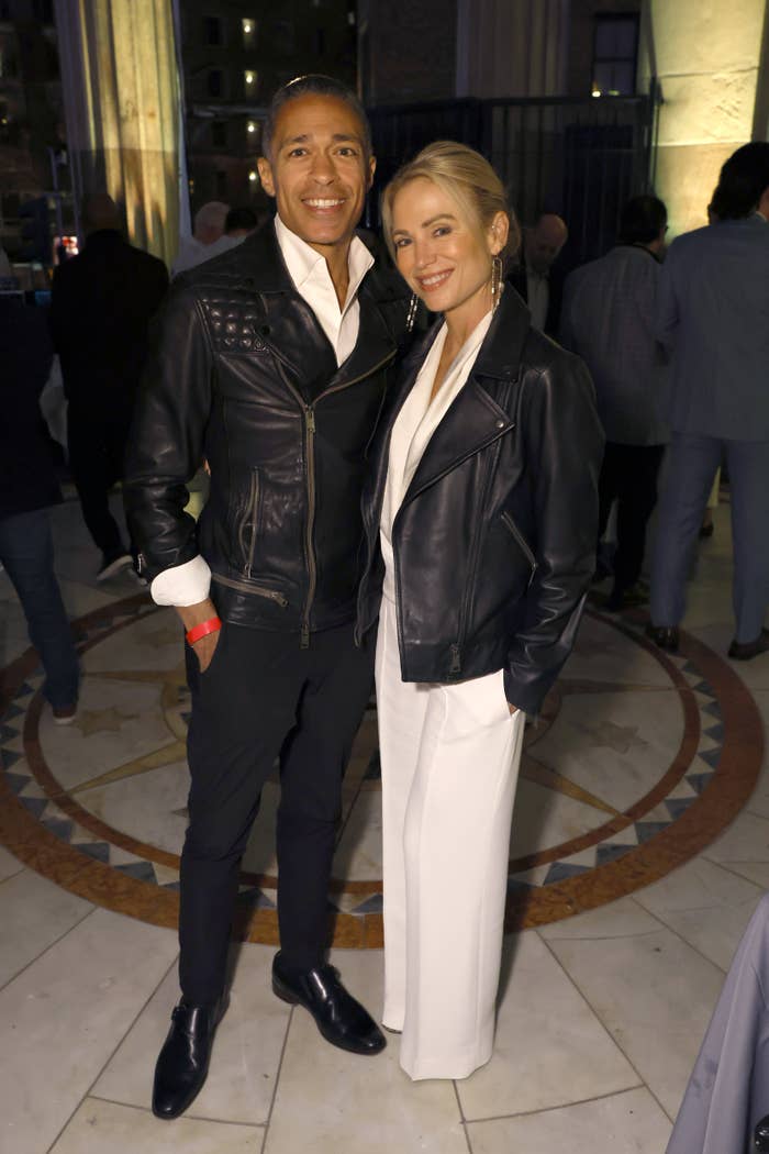 A smiling brace  successful  stylish leather jackets astatine  an event. The pistillate   wears elegant achromatic  attire, and the antheral   is successful  achromatic  pants with a achromatic  shirt