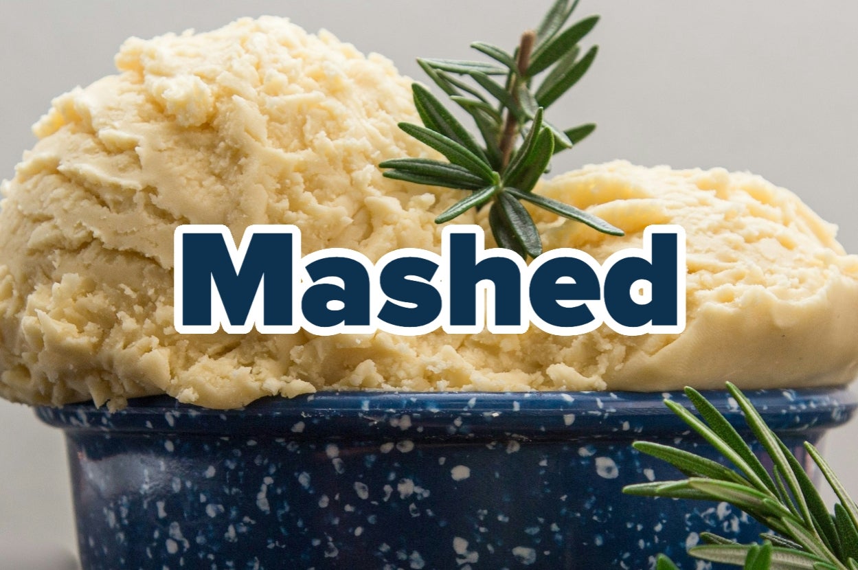 Mashed potatoes in a blue speckled bowl, garnished with rosemary, with the word "Mashed" overlaid