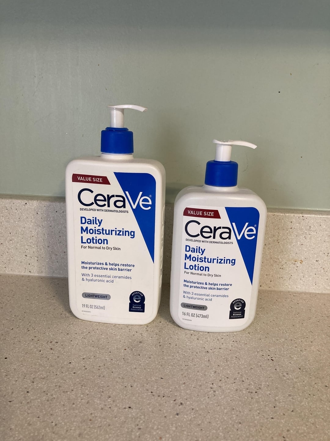 Two bottles of CeraVe Daily Moisturizing Lotion for mean   to adust  tegument  connected  a countertop