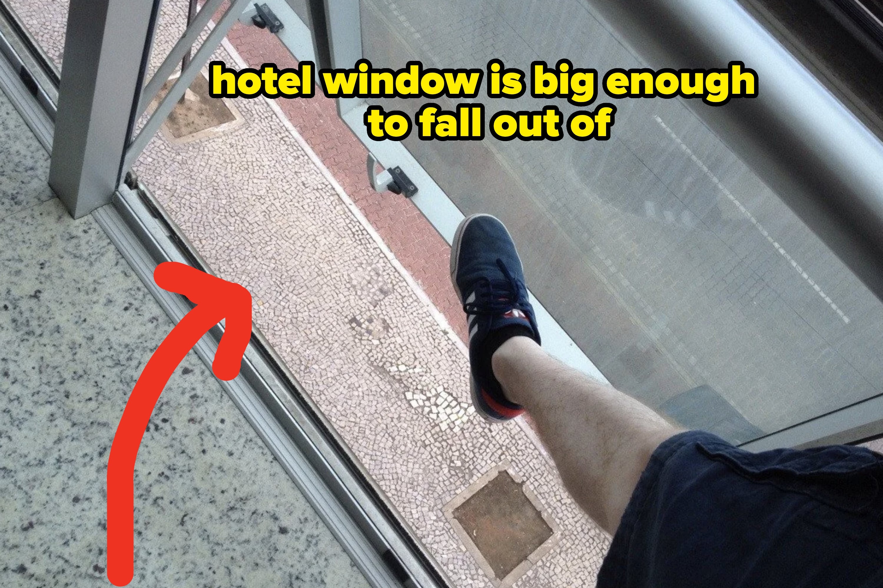 Person's leg extended stepping onto a balcony with a clear floor, overlooking lower floors