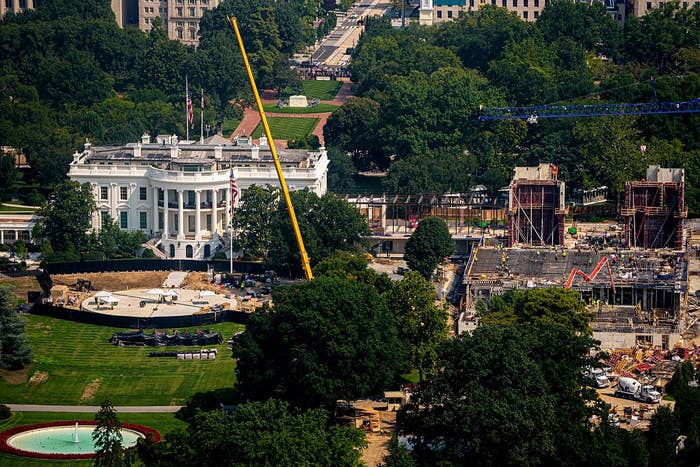 Aerial presumption    of the White House surrounded by trees, with a ample  operation  tract  and crane disposable   nearby