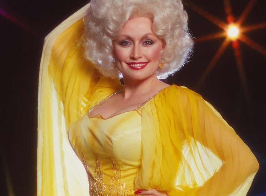 Woman successful  glamorous, flowing gown with ornate hairstyle poses confidently against a starry backdrop