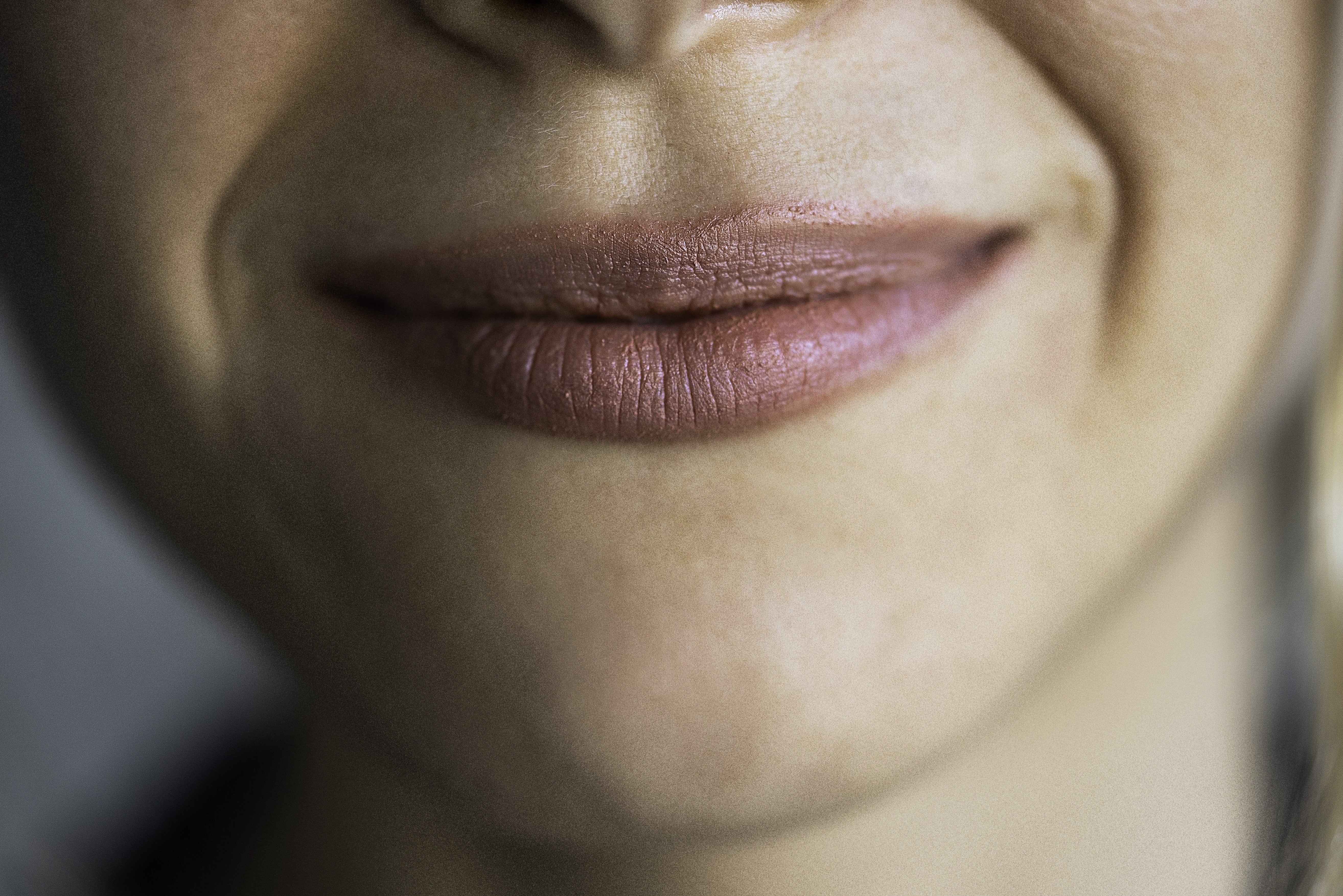 Close-up of a person's smiling lips and nose, creating a sense of warmth and friendliness