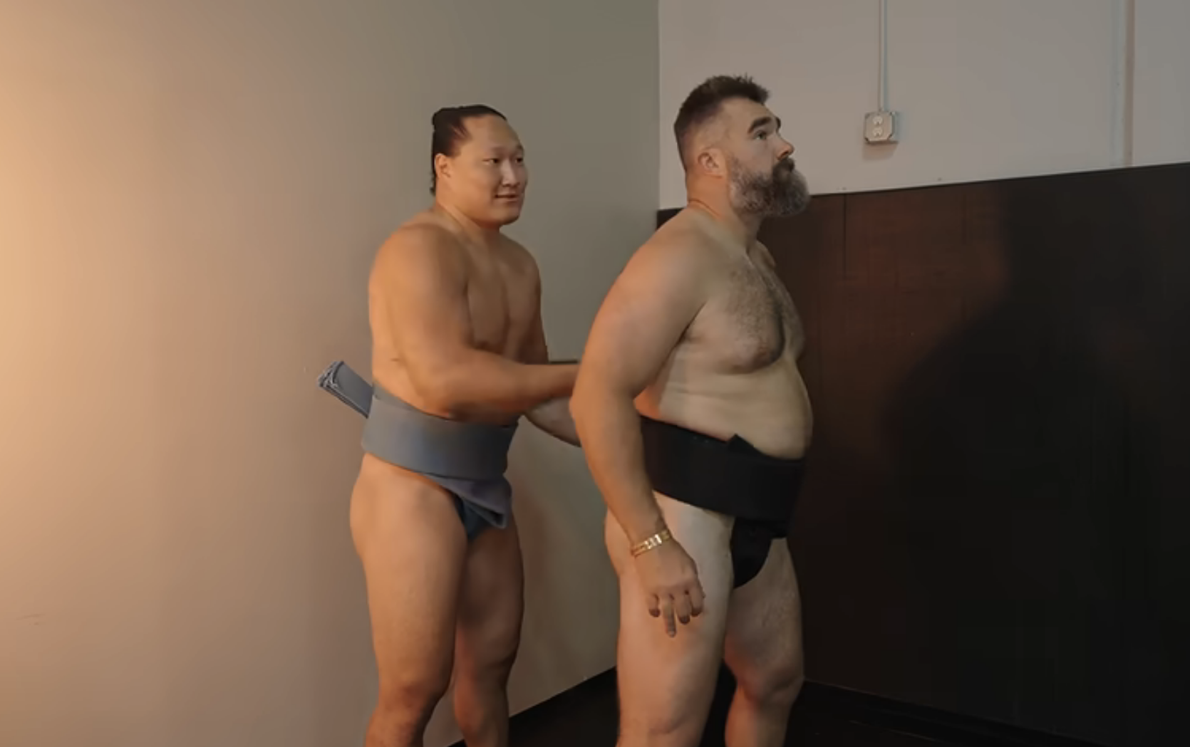 Jason, shirtless, preparing for sumo wrestling