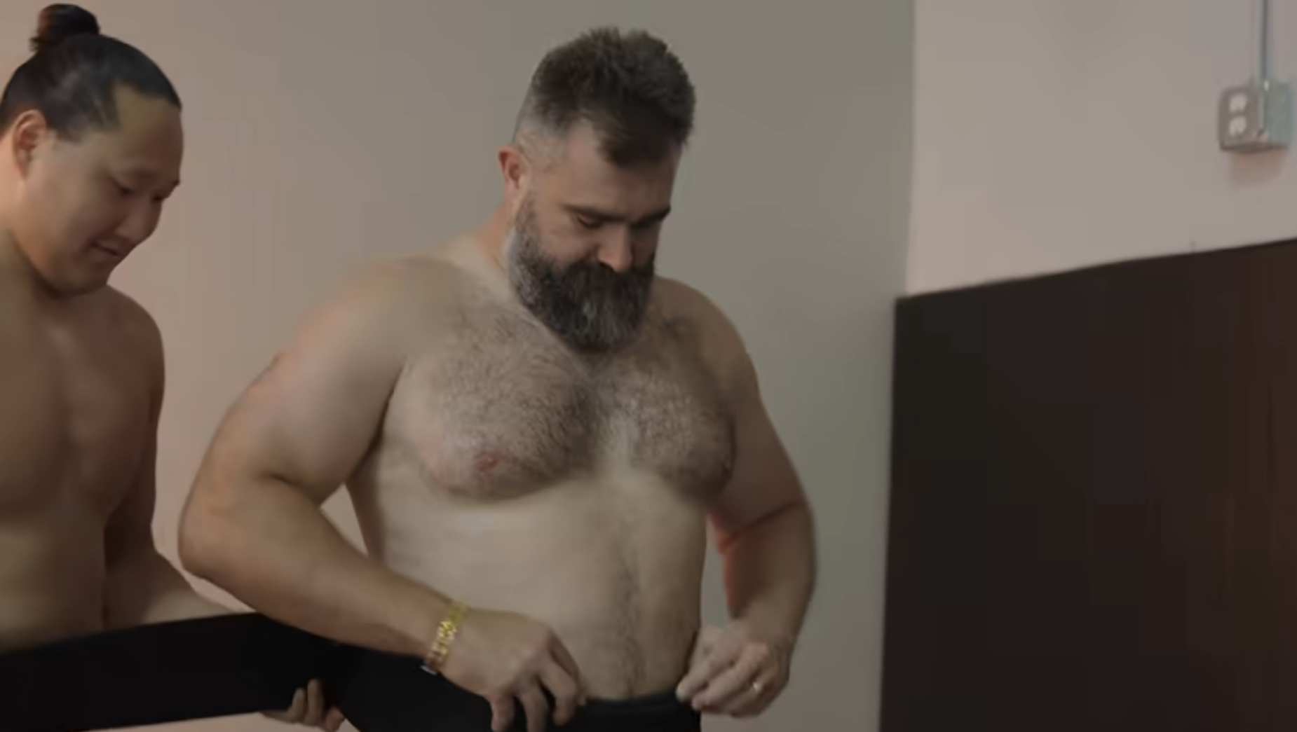 Jason, shirtless, preparing for sumo wrestling
