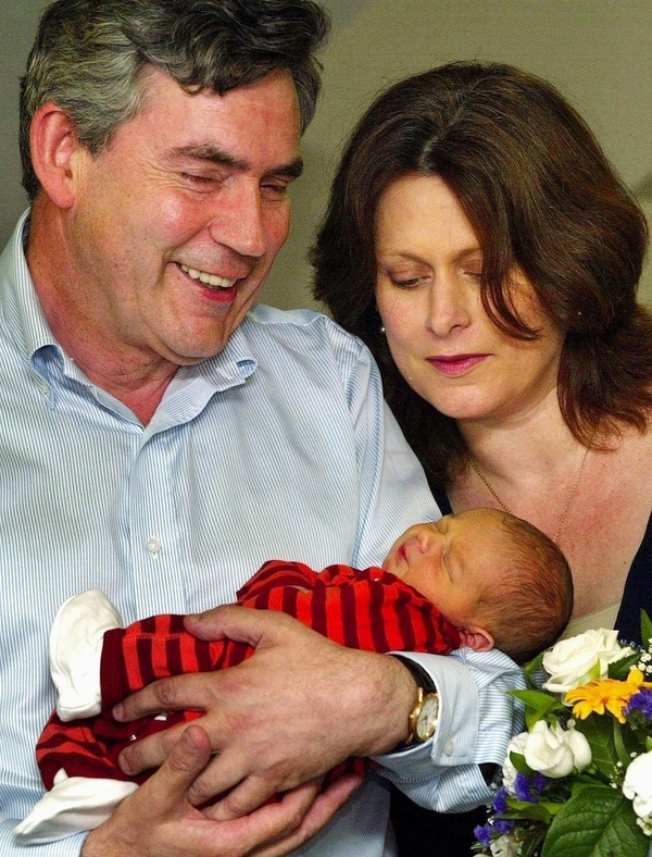 Britain&#39;s then Chancellor of the Exchequer Gordon Brown and wife Sarah pose with their son, J...