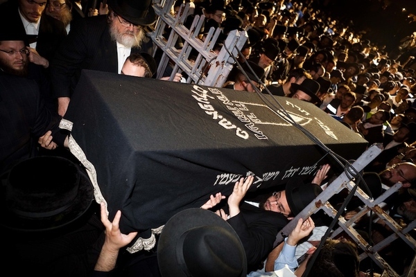 The casket carrying Leiby Kletzky, 8, is carried through a crowd of mourners for a funeral servic...