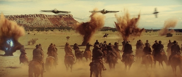 In this film publicity image released by Universal Pictures, a battle scene is shown in "Cowboys ...