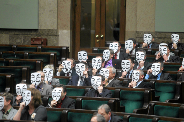 Members of Ruch Palikota Party wear masks during a vote of no confidence for Health Minister Bartosz Arlukowicz in Poland's parliament in Warsaw.