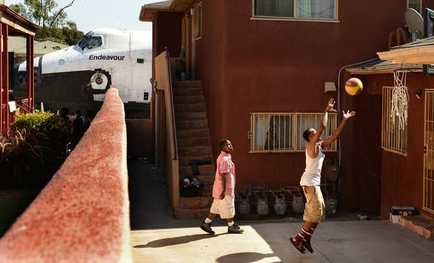 "Traymond Harris (L) and Ryan Hudge play basketball as Space Shuttle Endeavour travels to the California Science Center on Crenshaw Ave in Inglewood, Los Angeles on Saturday.The shuttle was moving at 2mph, so no high speed lens needed.