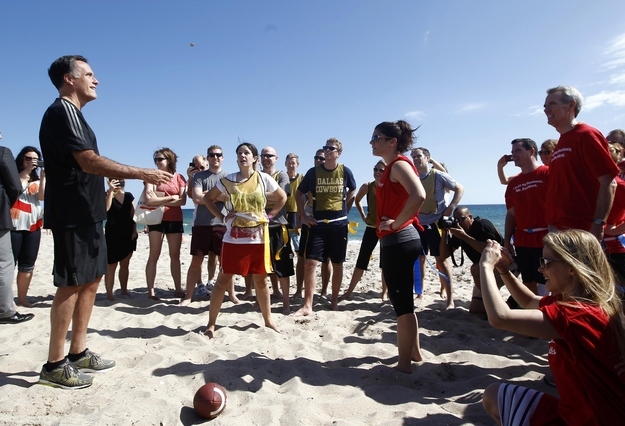 Republican presidential nominee and former Massachusetts Governor Mitt Romney takes part in a coin toss for a touch football game in Delray Beach, Florida, October 21, 2012.
