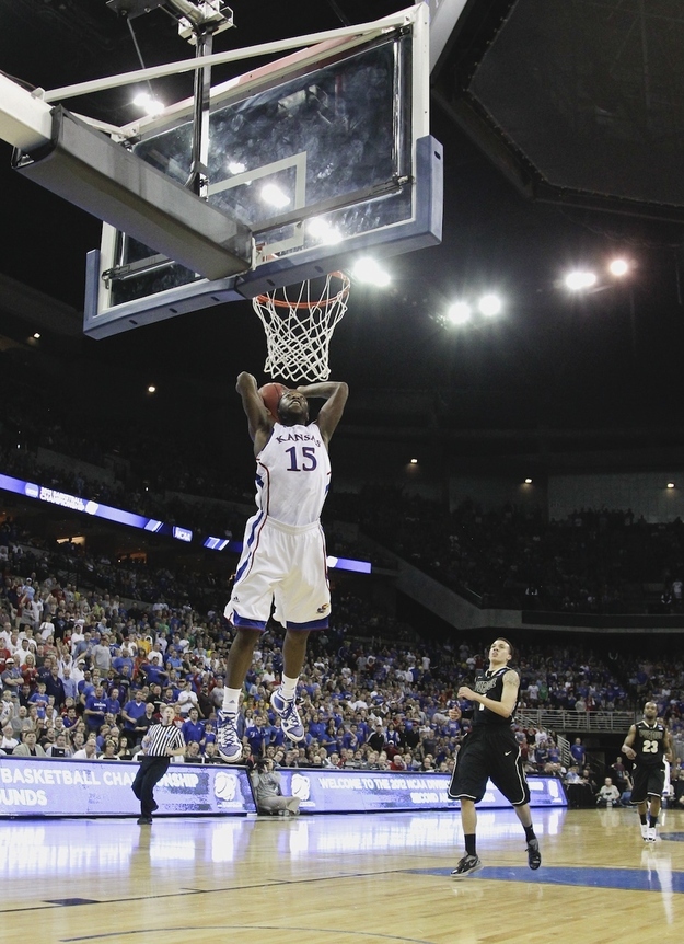 Prudue's Anthony Johnson (1) looks on as Kansas' Elijah Johnson dunks in their NCAA tournament third-round college basketball game at CenturyLink Center in Omaha, Neb., Sunday, March 18, 2012. Kansas won 63-60.