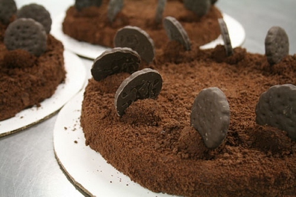 The baker's description: "A decadent flourless chocolate mint cake, enrobed in chocolate, and then completely covered in chocolate mint cookie crumbles. Topped with chocolate crunch truffles presenting the revered Girl Scout Thin Mint cookies."