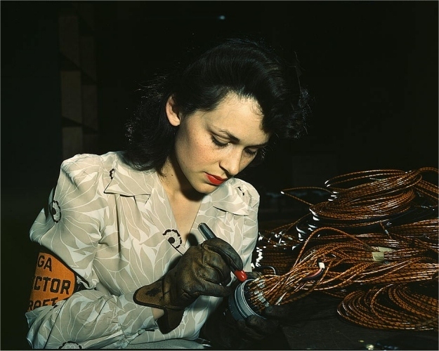 Woman aircraft worker checking electrical wiring. Photographed by David Bransby in June 1942.