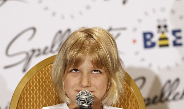 Six-year-old Lori Anne Madison ponders upon a question during a news conference at the Scripps National Spelling Bee semi-finals at National Harbor, Maryland May 31, 2012. Madison, who was eliminated in Wednesday's round, is the youngest speller in the Spelling Bee's history.