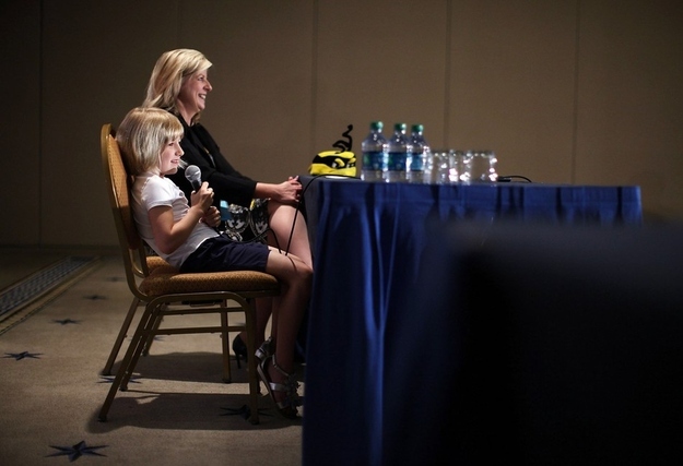 WASHINGTON, DC - MAY 31: Six-year-old Lori Anne Madison (L) of Woodbridge, Virginia, speaks as Spelling Bee Director Paige Kimble (R) listens during a news conference at the 84th annual Scripps National Spelling Bee competition May 31, 2012 at the Gaylord National Resort and Convention Center in National Harbor, Maryland. Madison was the youngest competitor in the history of the Bee. She was eliminated in round 3 after she misspelled the word 'ingluvies' the day before.