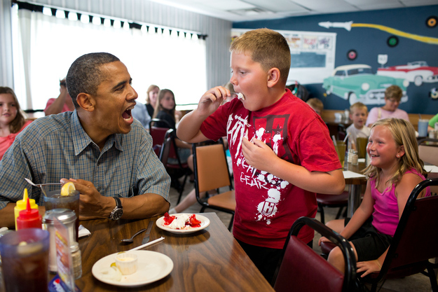 President Barack Obama shares his strawberry pie with a boy during a lunch stop at Kozy Corners restaurant in Oak Harbor, Ohio, July 5, 2012.