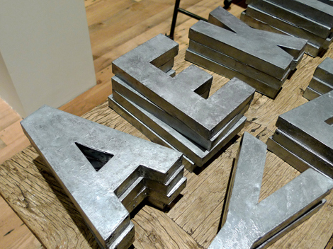 Spraypaint papier-m&acirc;ch&eacute; letters to create zinc alphabet letters.