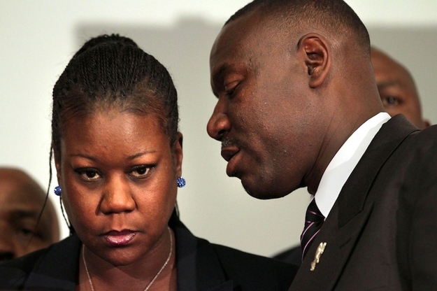 Trayvon Martin's mother Sybrina Fulton, left, listens to the family attorney Benjamin Crump, during a news conference at the Washington Convention Center in Washington, Wednesday, April 11, 2012.
