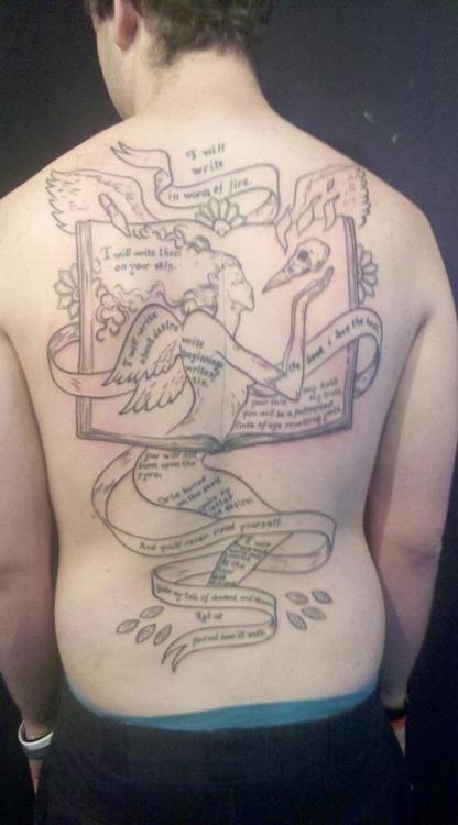 Neil Gaiman's poem "I Will Write Words of Fire" was tattooed on Burton Olivier's back, along with an image designed by comic book artist David Mack.