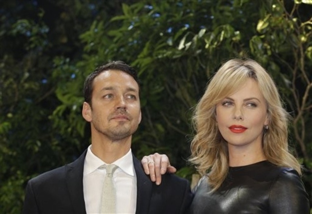 The director (pictured with Charlize Theron) grew up in London with both parents - his mother who ran a doll house shop and his father who was a a neuro-ophthalmic surgeon.