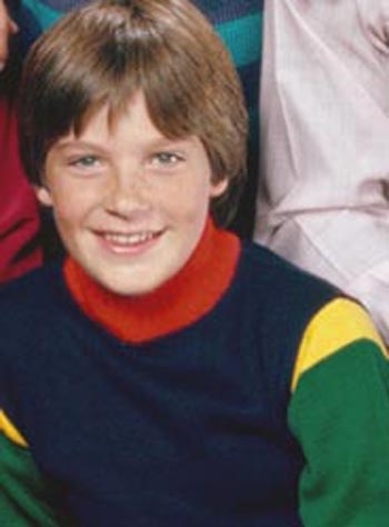Look at this multi-colored turtleneck wearing rascal!