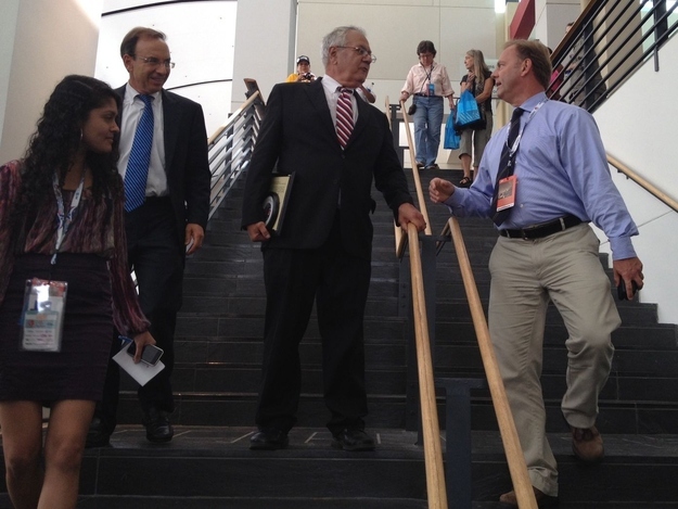 Rep. Barney Frank, center, speaks to a reporter after addressing the LGBT Caucus at the Democratic National Convention.
