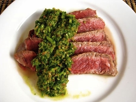 Originally from Argentina, chimichurri is a delicious marinade for chicken and can be used as a spread for many other grilled dishes. Its ingredients are chopped parsley, minced garlic, vegetable oil, white (or red) vinegar, and red pepper flakes. It's pretty spicy and tangy, with a number of different variations for additional flavors. Best of all, you can purchase it or make it on your own, and it's relatively easy to do so.