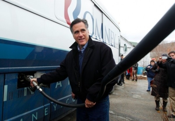 Mitt Romney pumps gas in his campaign bus.
