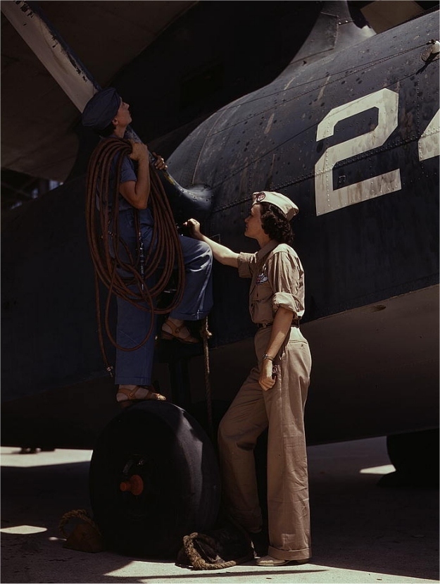 Cora Ann Bowen (left), employed as a cowler, at work at Corpus Christi Naval Air Base. Eloise J. Ellis (right) is a senior supervisor in the Assembly and Repairs department. Photographed by Howard R. Hallem in August 1942.