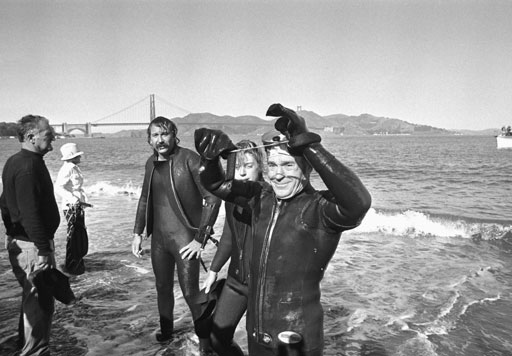 Fitness legend Jack LaLanne emerges from the ocean after setting a record for swimming the length of the Golden Gate Bridge while towing 140 pounds of equipment.